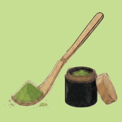 Bamboo scoop of matcha beside the tin